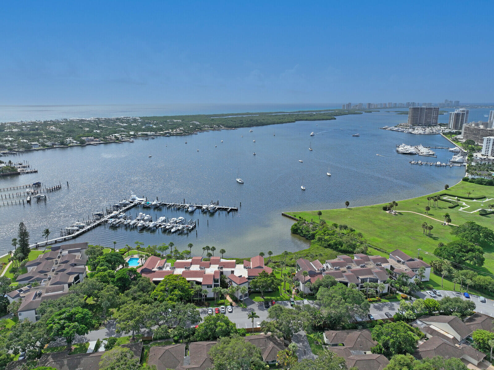 an aerial view of a house with a yard and lake view