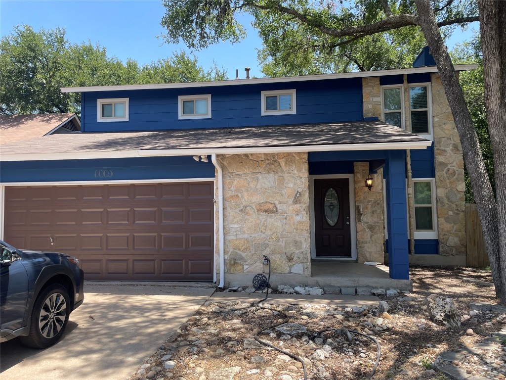 a front view of a house with parking space