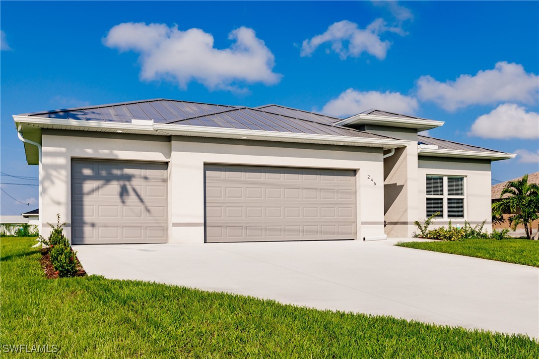 a front view of a house with a yard and garage