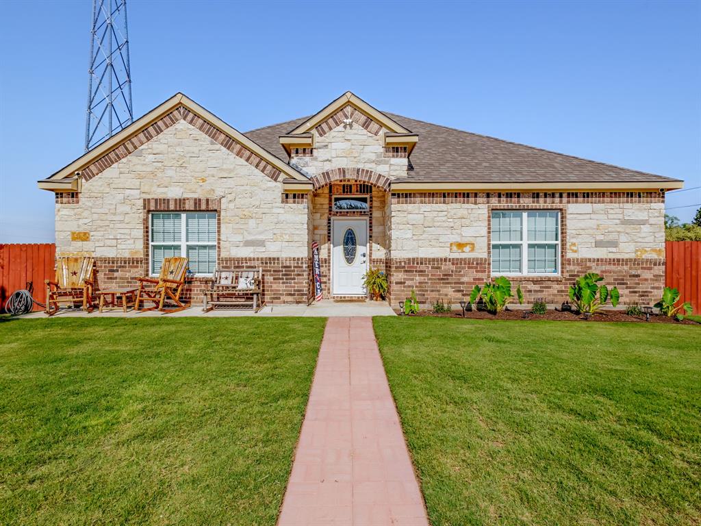 a front view of house with yard and green space