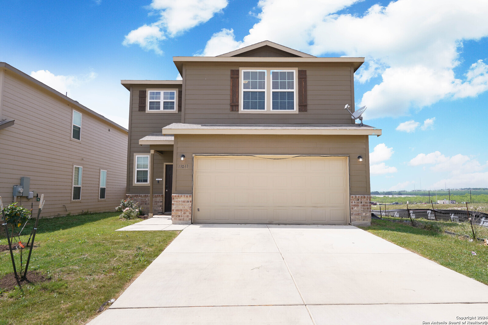 a front view of a house with a yard and garage