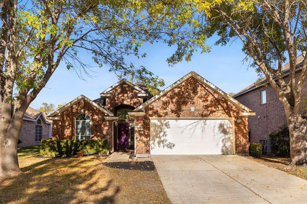 a view of a house with a tree in front