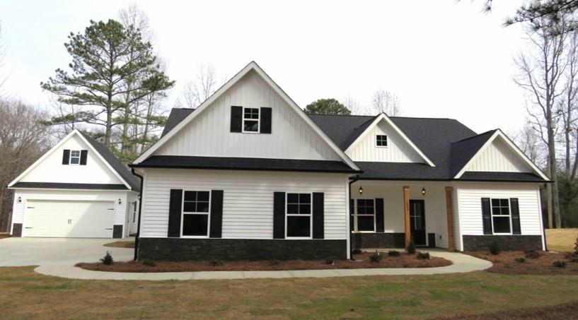 a front view of a house with yard and green space