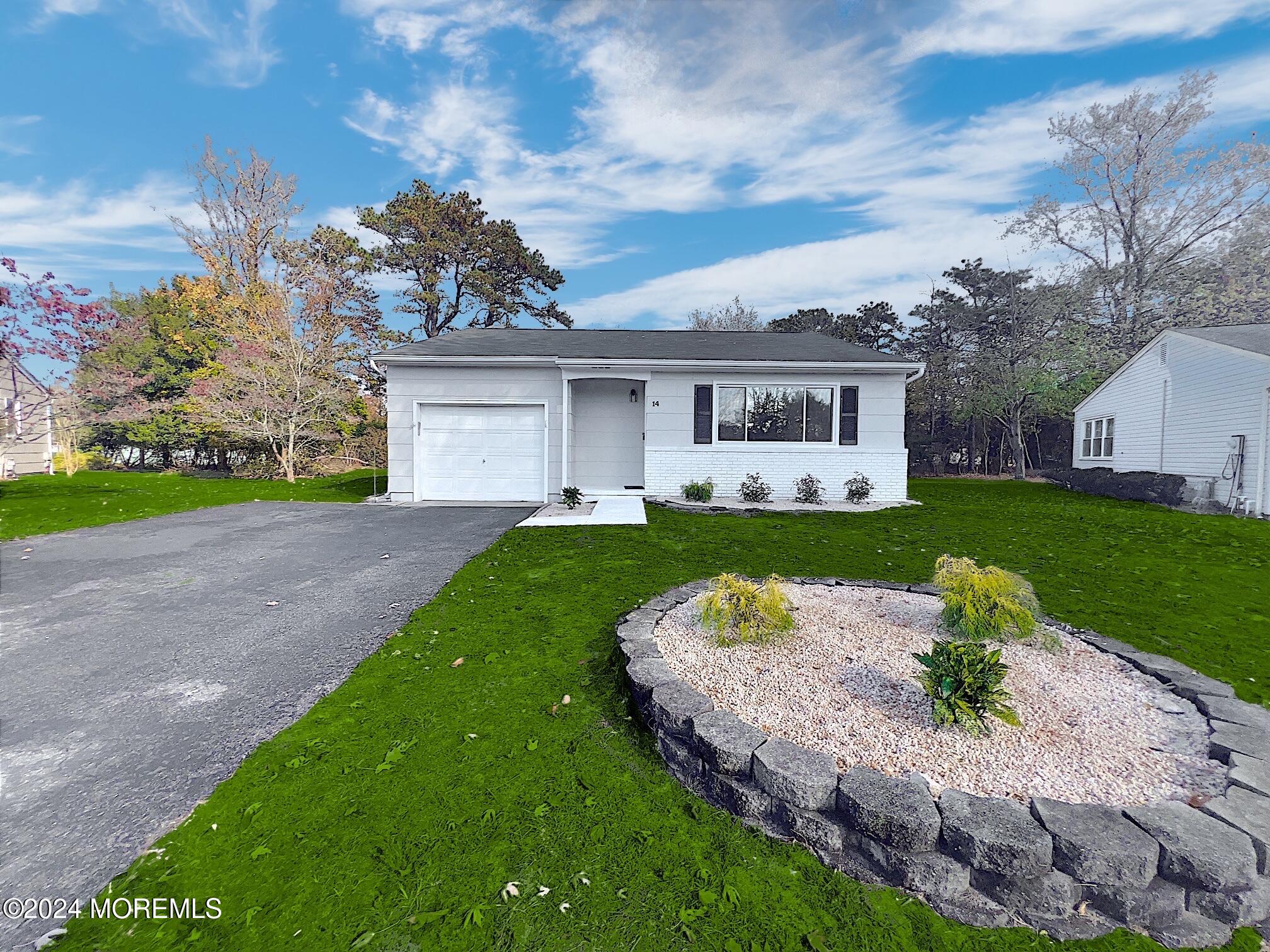 a front view of house with yard and green space