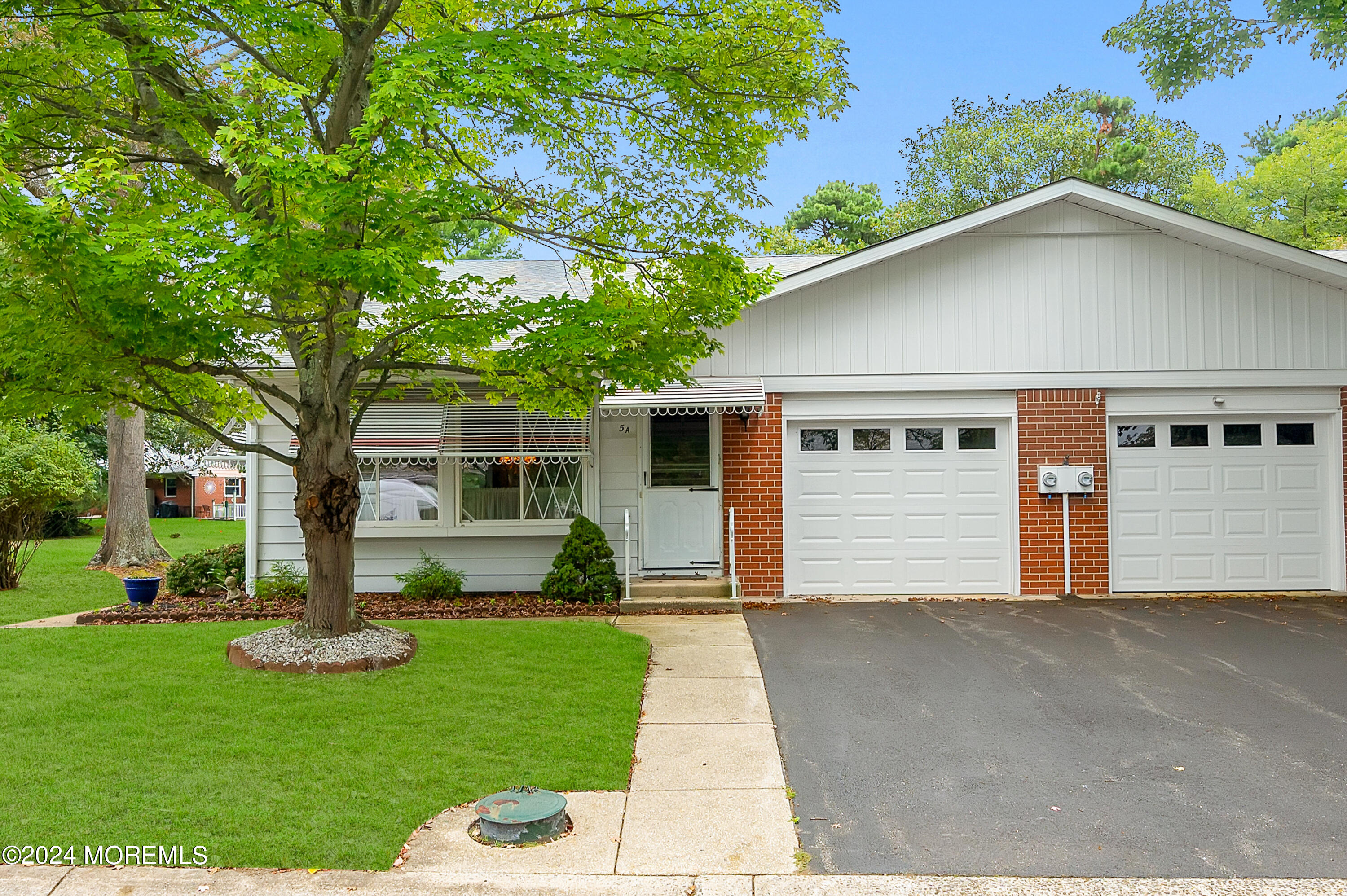 a front view of house with yard and green space