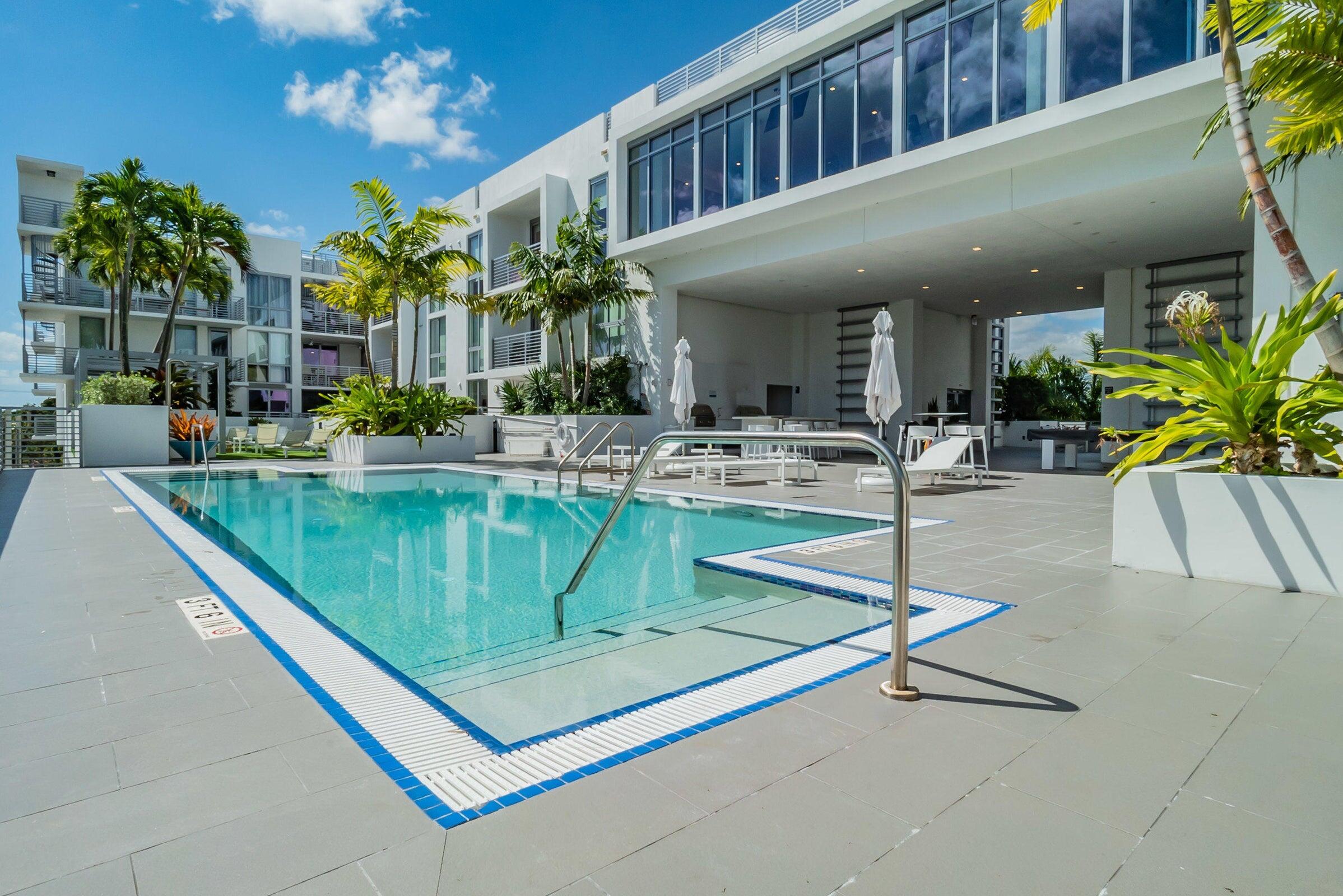 a swimming pool with outdoor seating and yard