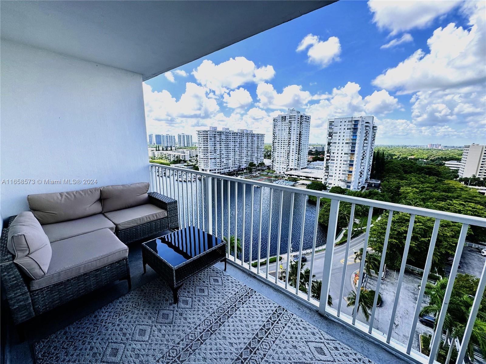 a view of a balcony with wooden chairs