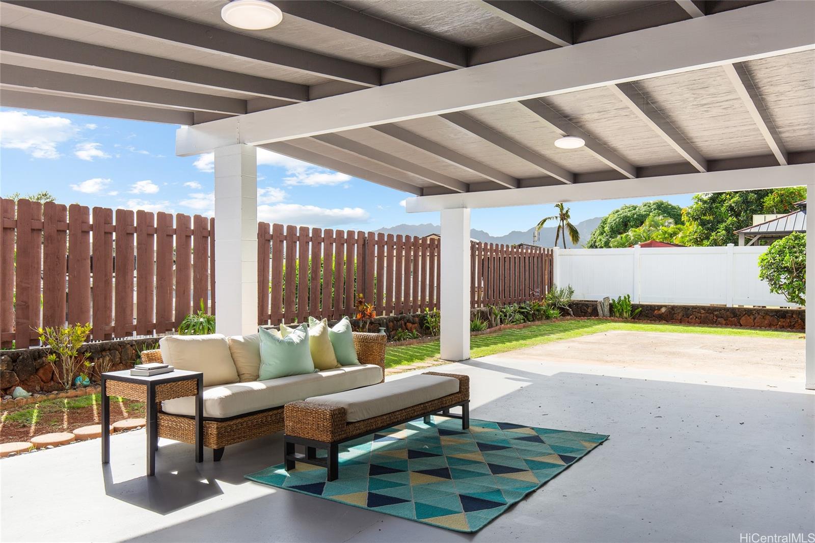 a swimming pool with outdoor seating and yard