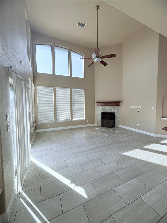 a view of an empty room with a fireplace and a window