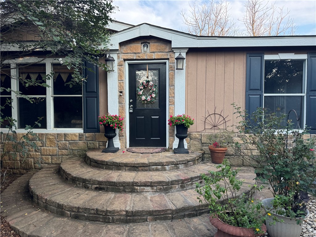 a view of a house with potted plants