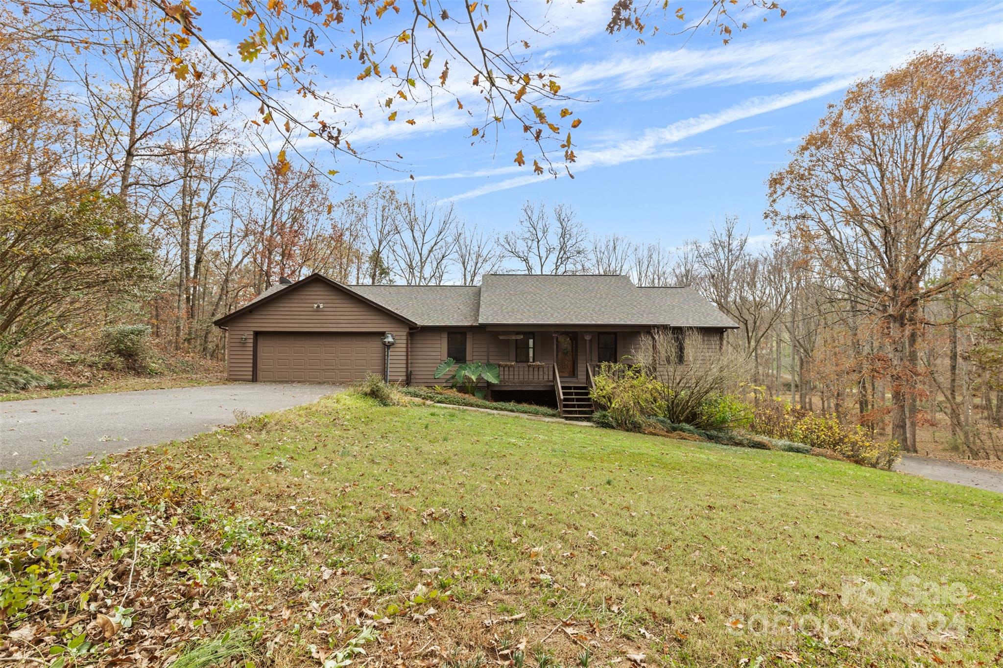 a front view of house with yard and trees