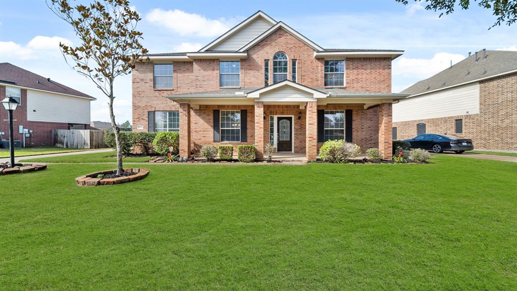 a view of a house with a yard and sitting area