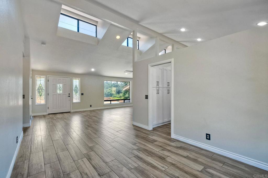 a view of a room with wooden floor and potted plant