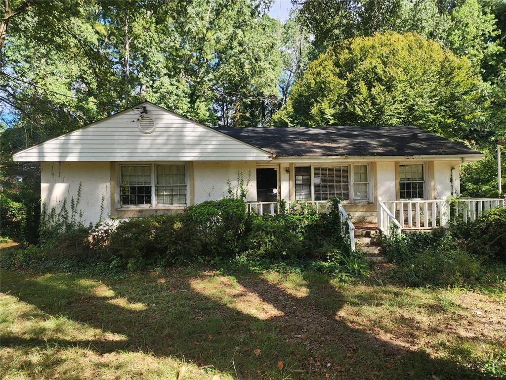 a front view of a house with a yard and green space