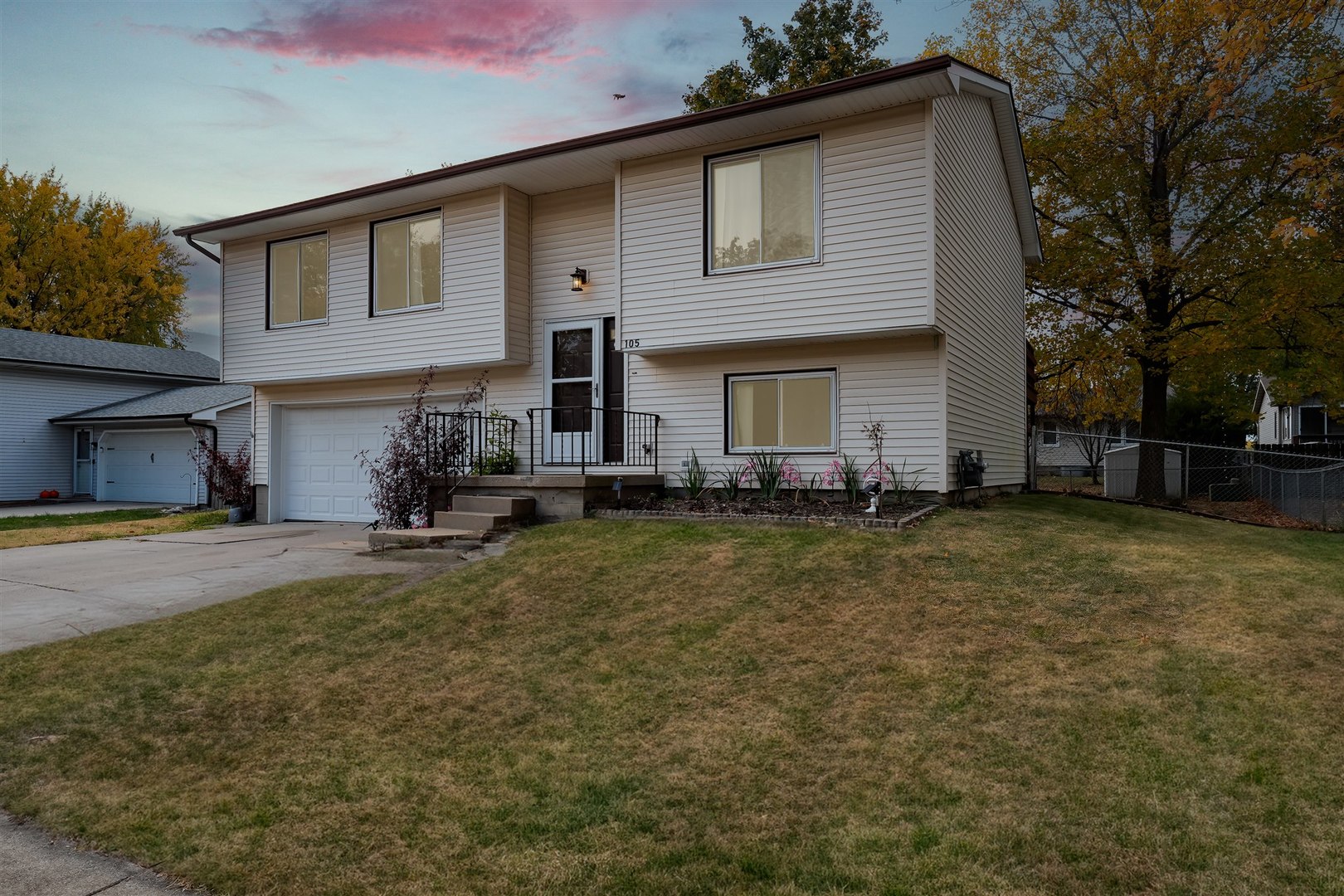 a view of a house with backyard and sitting area