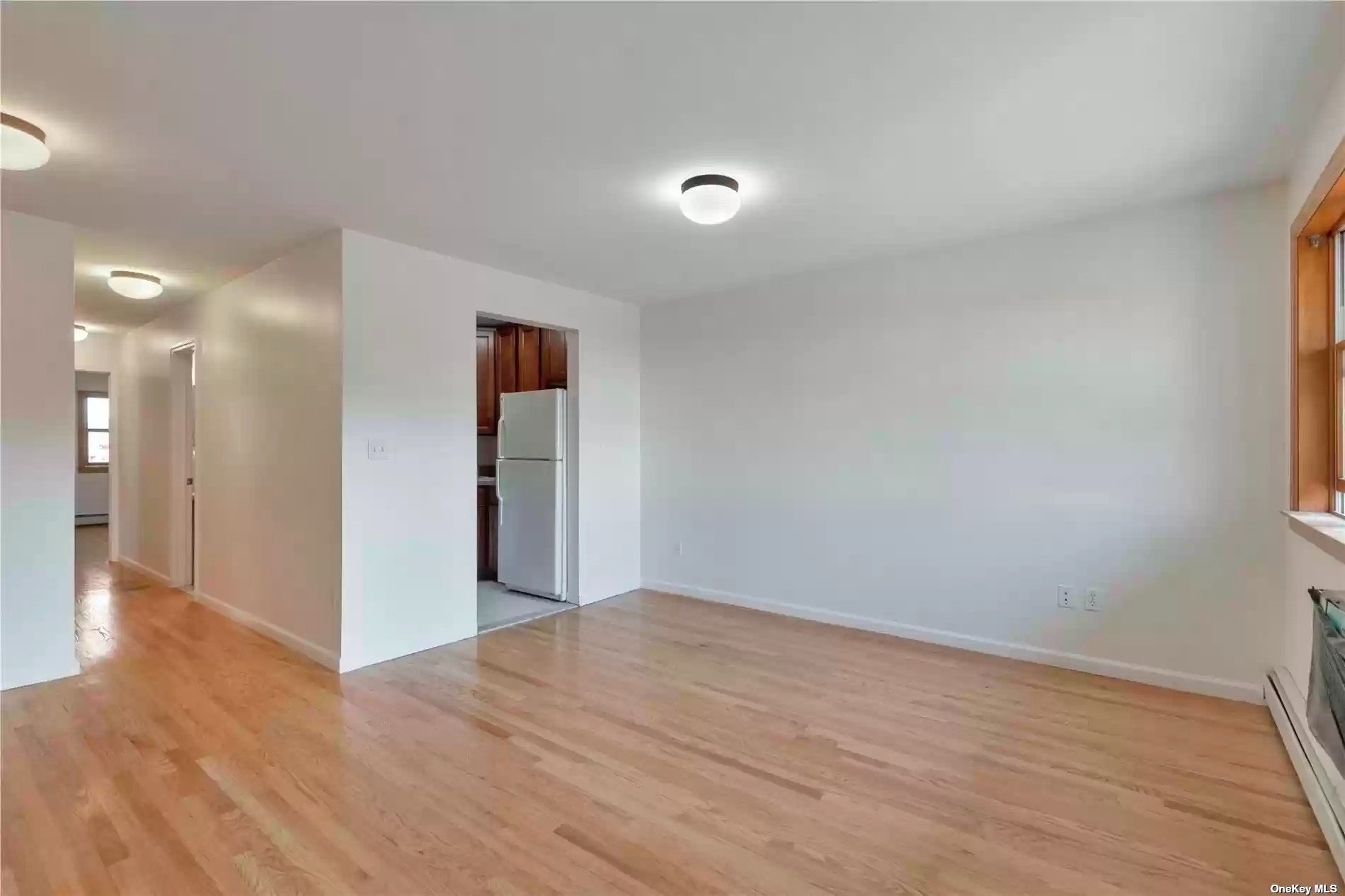 a view of hallway with wooden floor