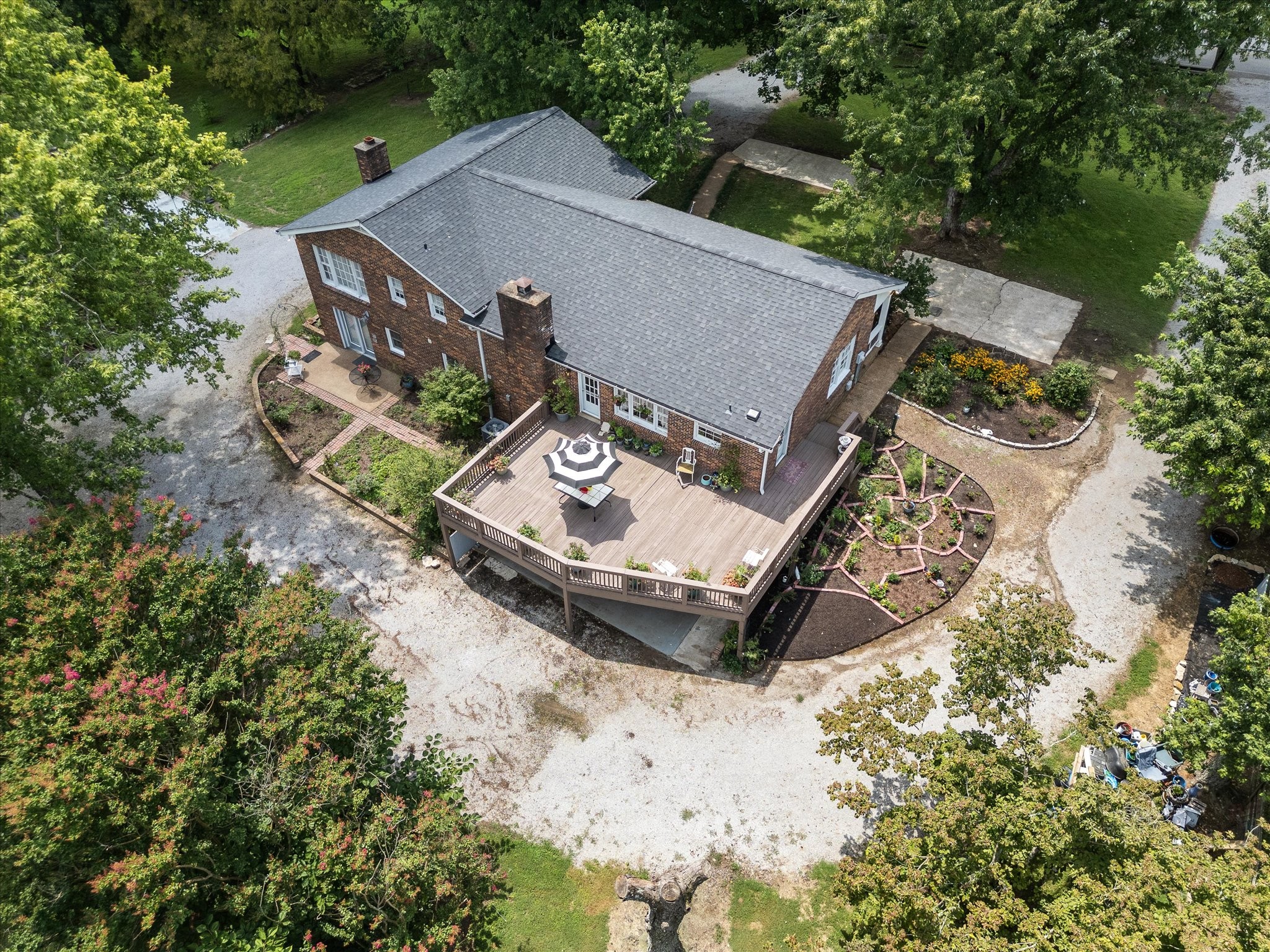 an aerial view of a house with yard and mountain view in back