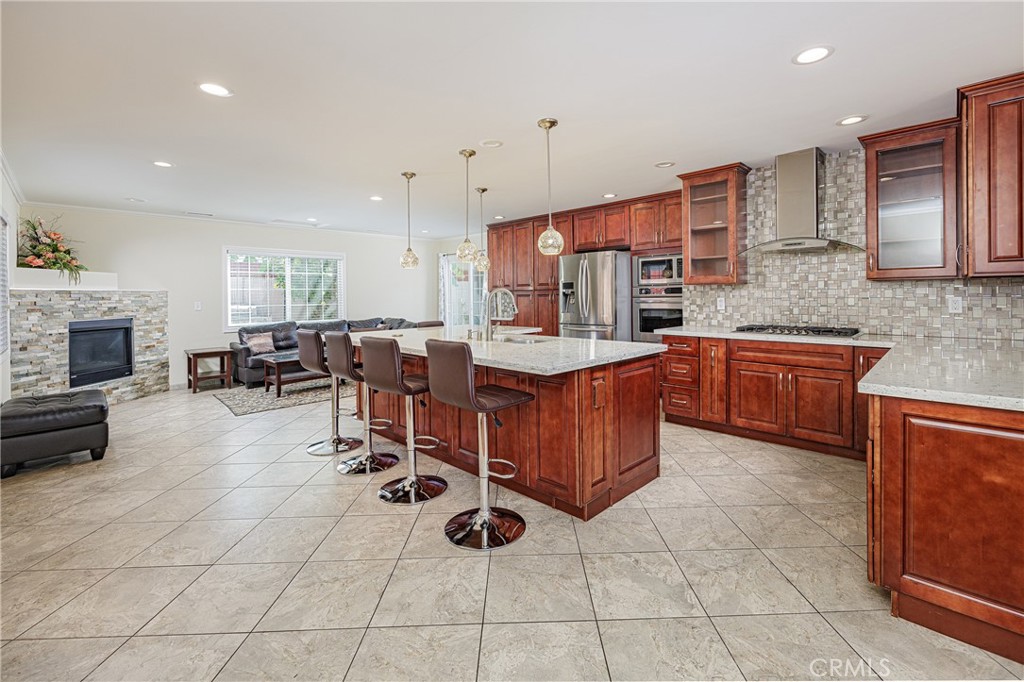 a kitchen with stainless steel appliances a sink a stove a counter top space and cabinets