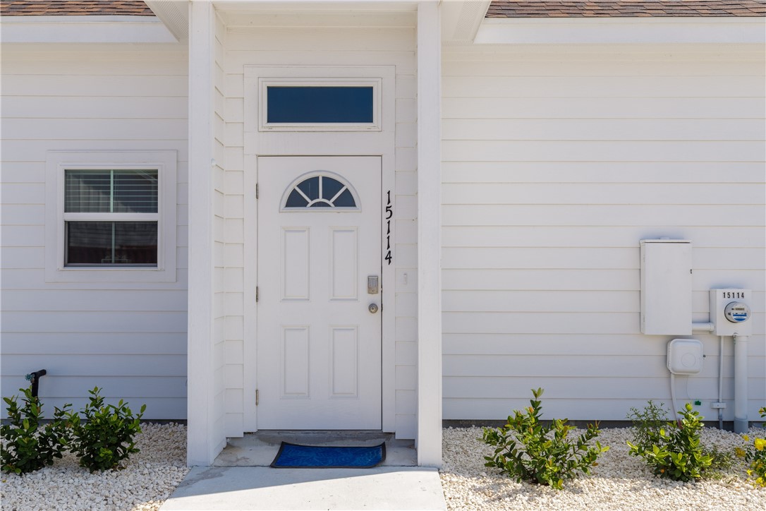 a view of front door and potted plants