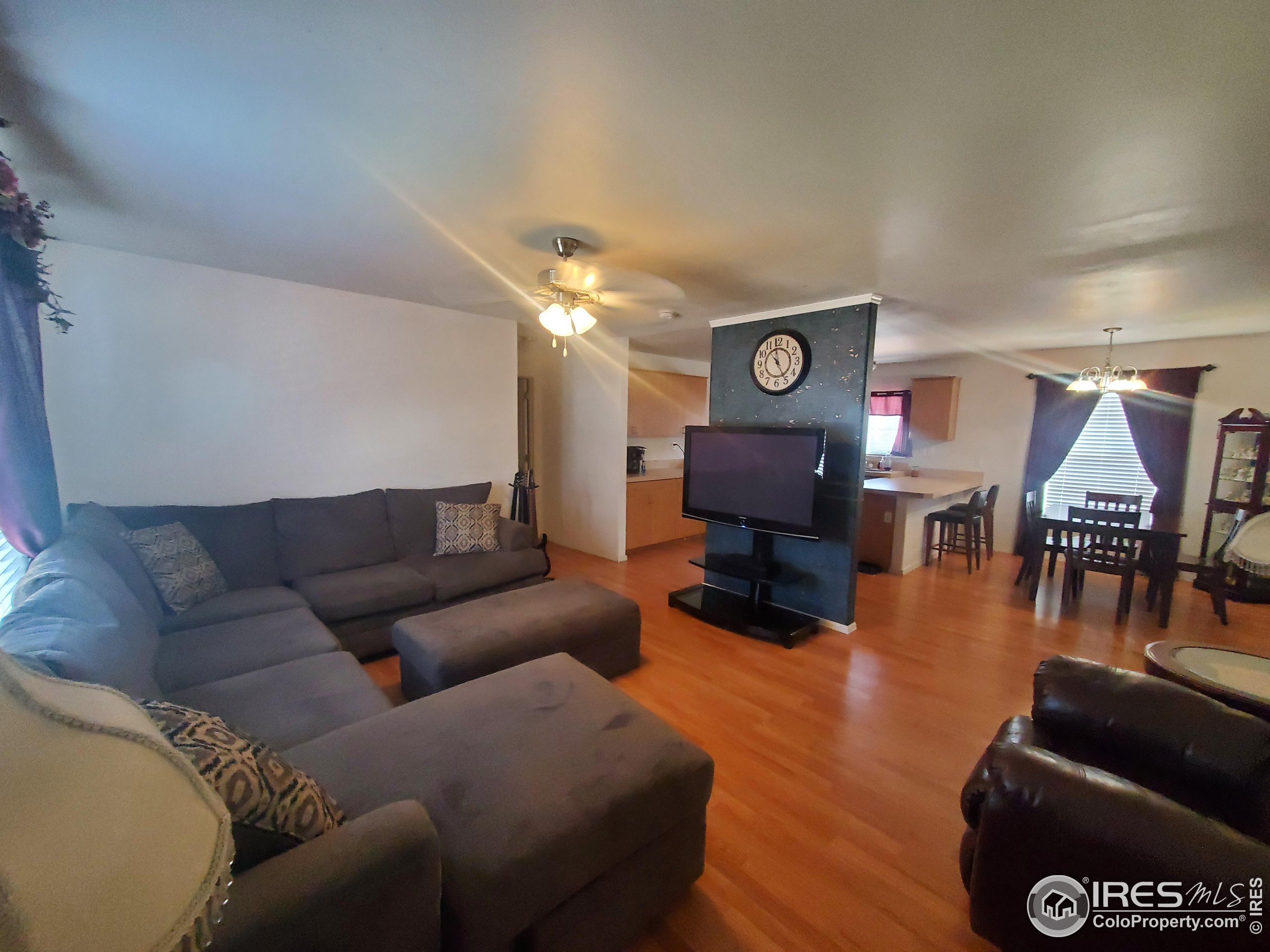 a living room with furniture and a clock