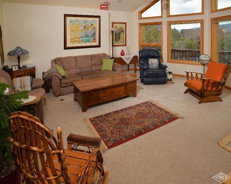 a living room with furniture rug and a large window