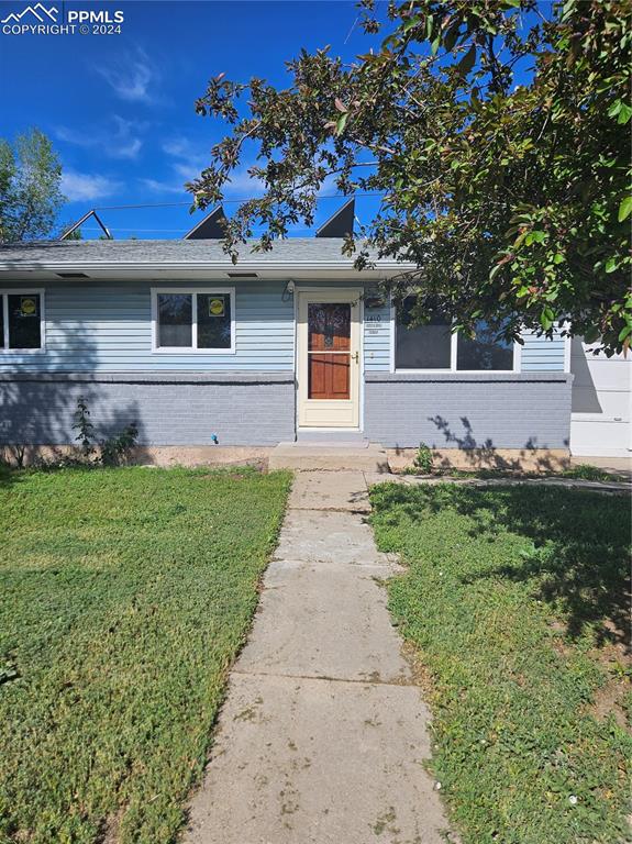 View of front of property with a front yard, New windows, screen door.