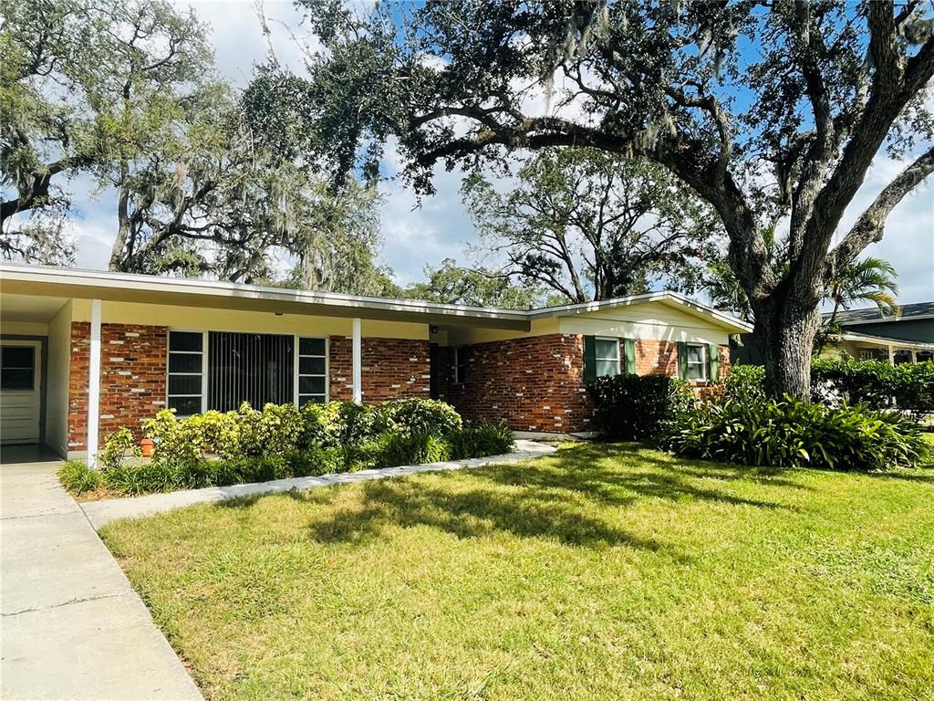 a front view of house with yard and green space