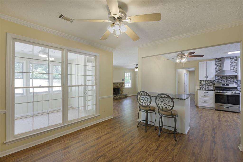 a dining room with furniture and wooden floor