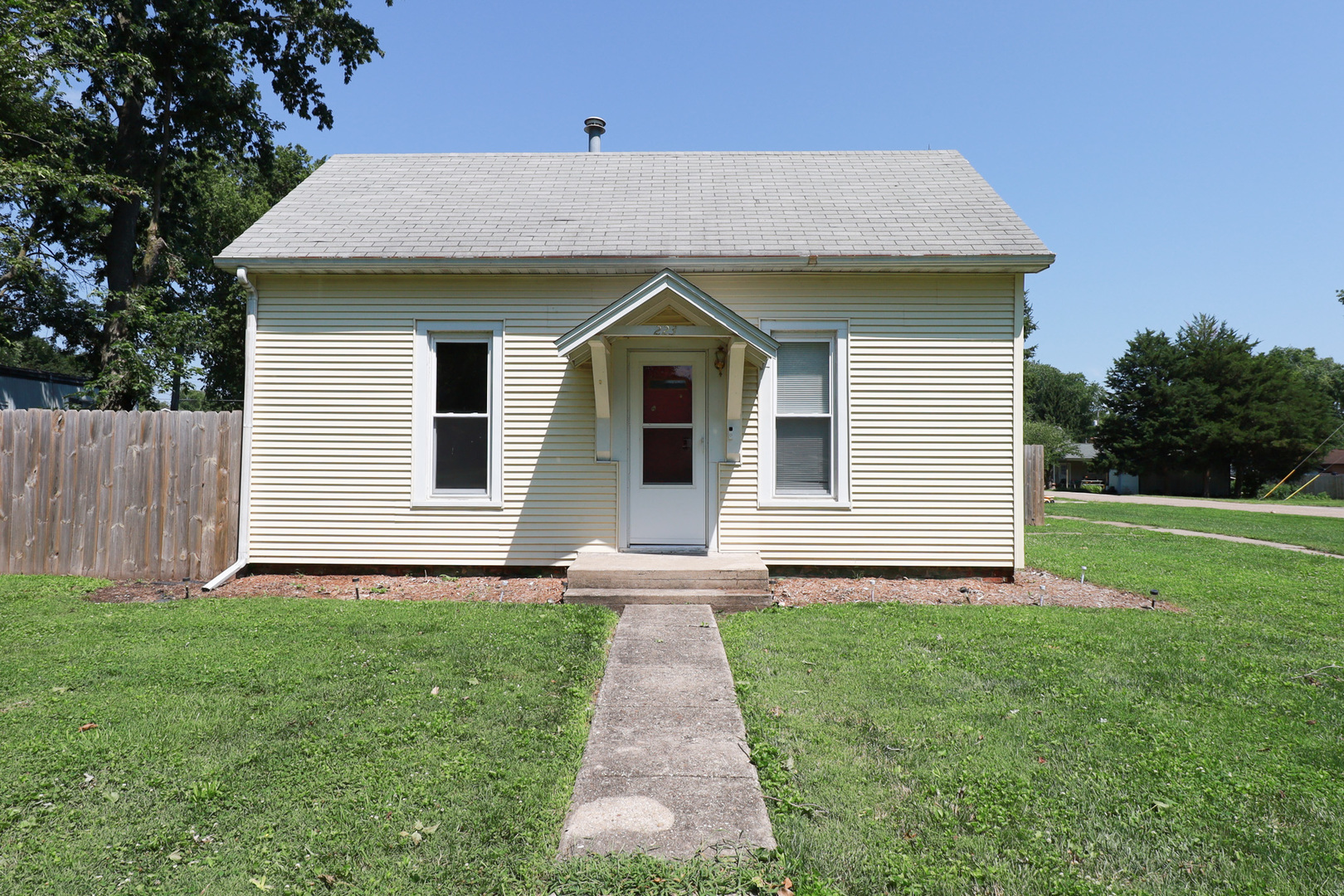 a front view of house with yard and green space