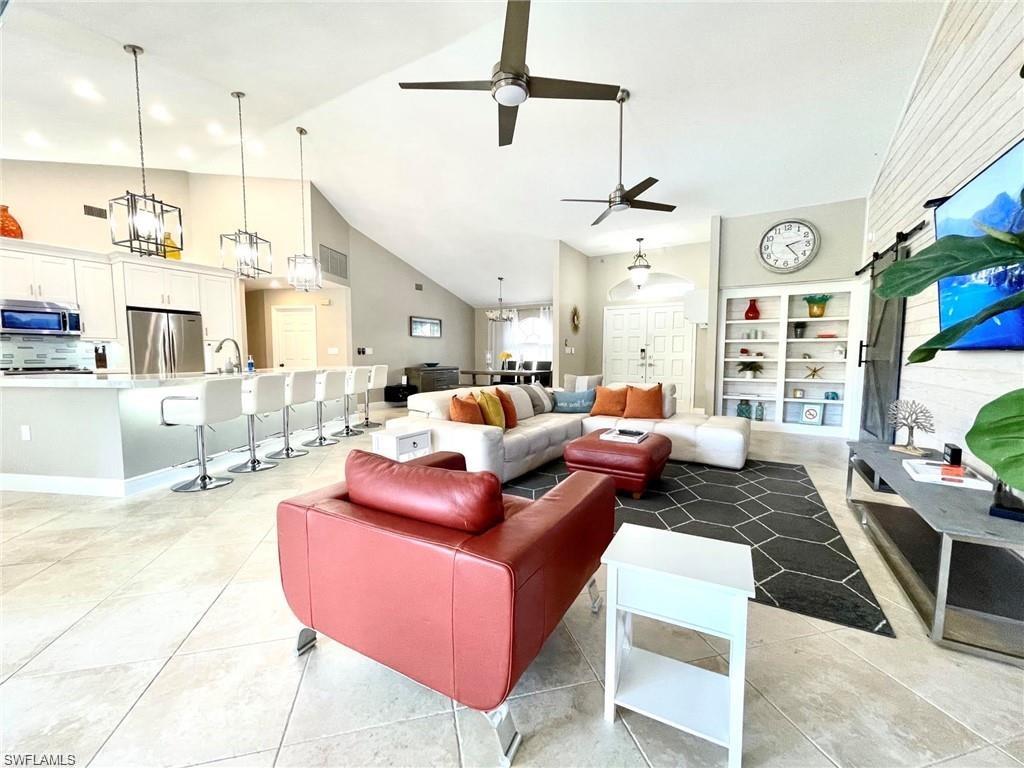 a living room with furniture a rug and a chandelier