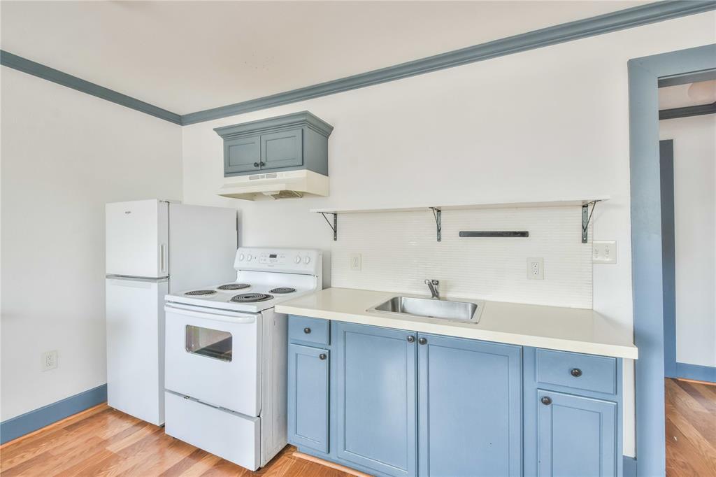 a kitchen with a stove a sink and a refrigerator