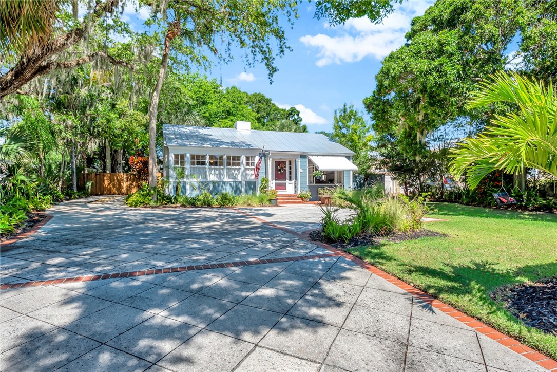 a view of house with outdoor space and garden