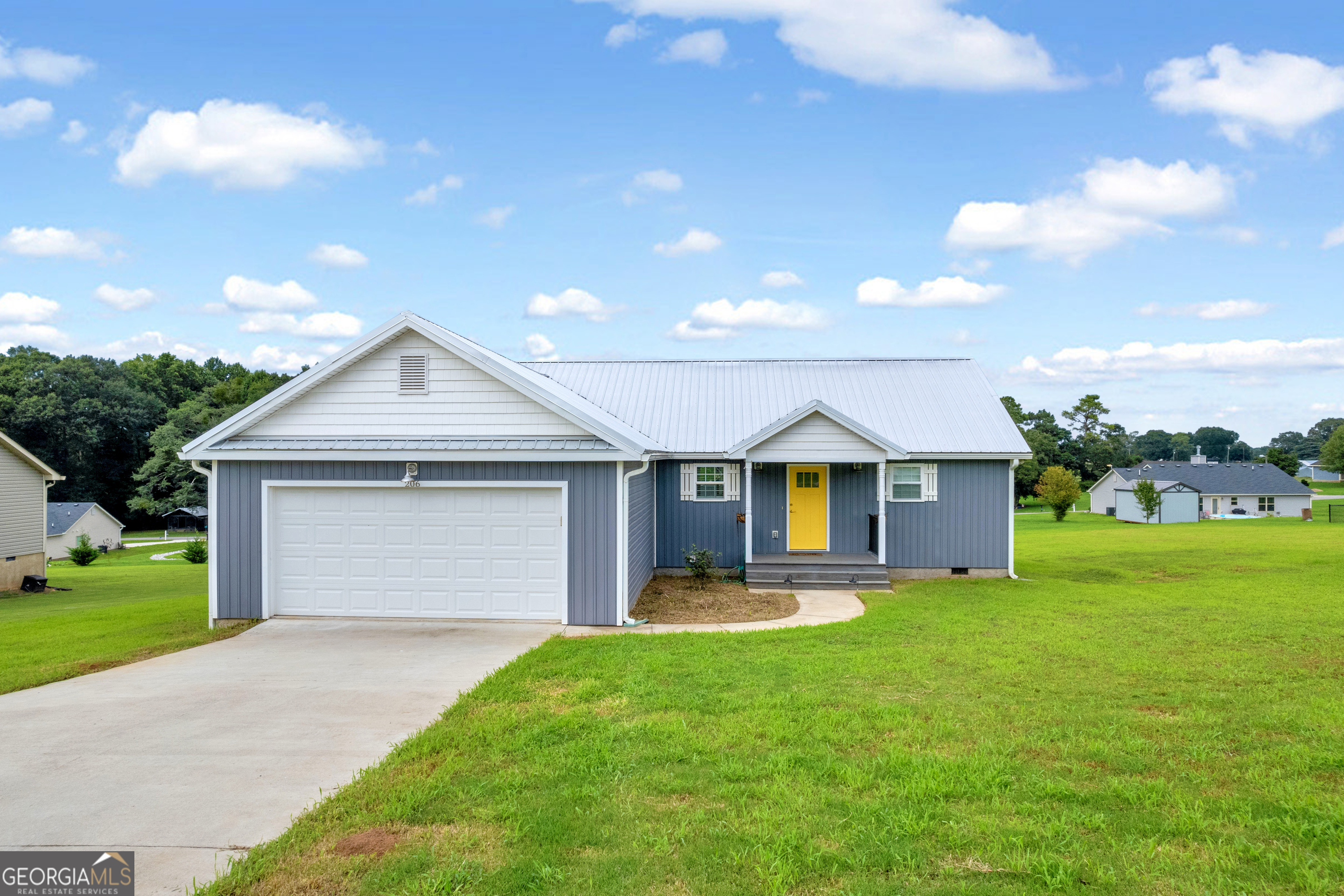 a front view of house with yard and green space