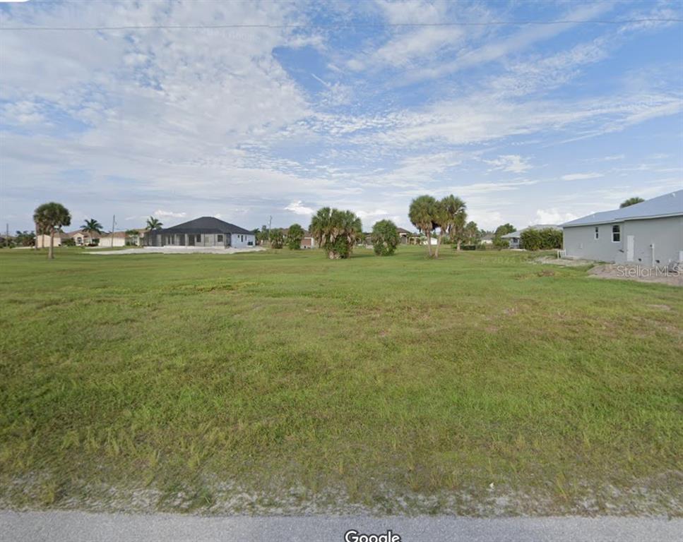 a view of a field with an ocean view