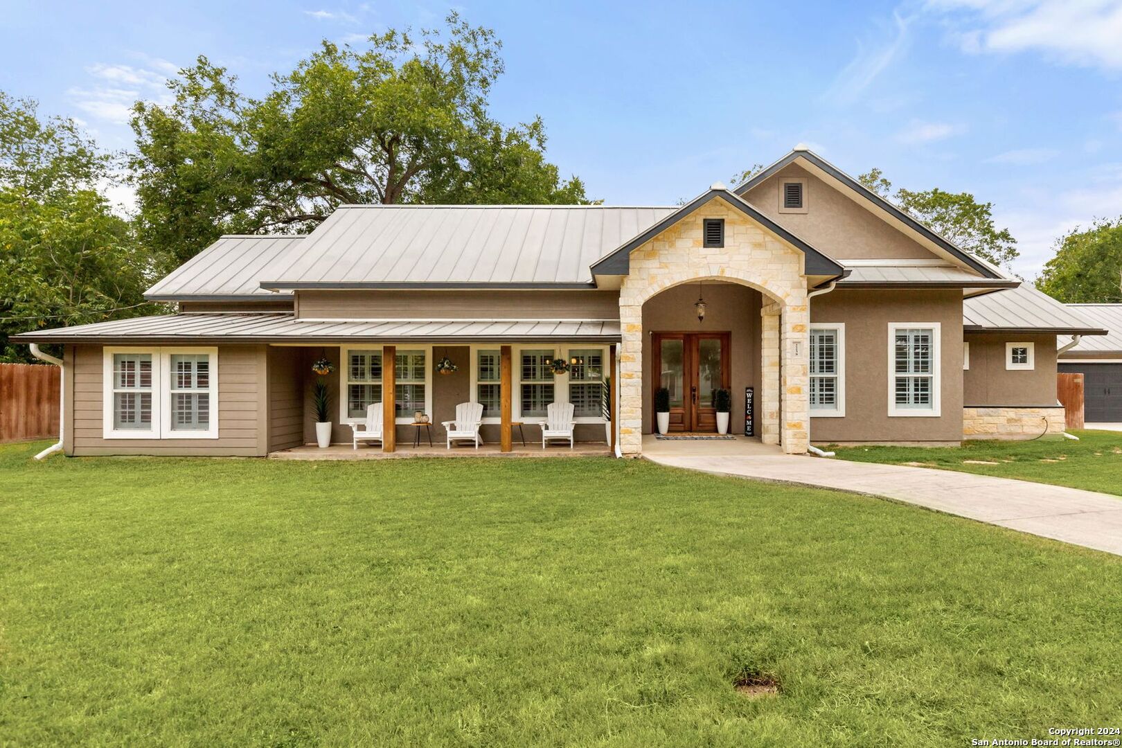 a front view of a house with a garden and porch