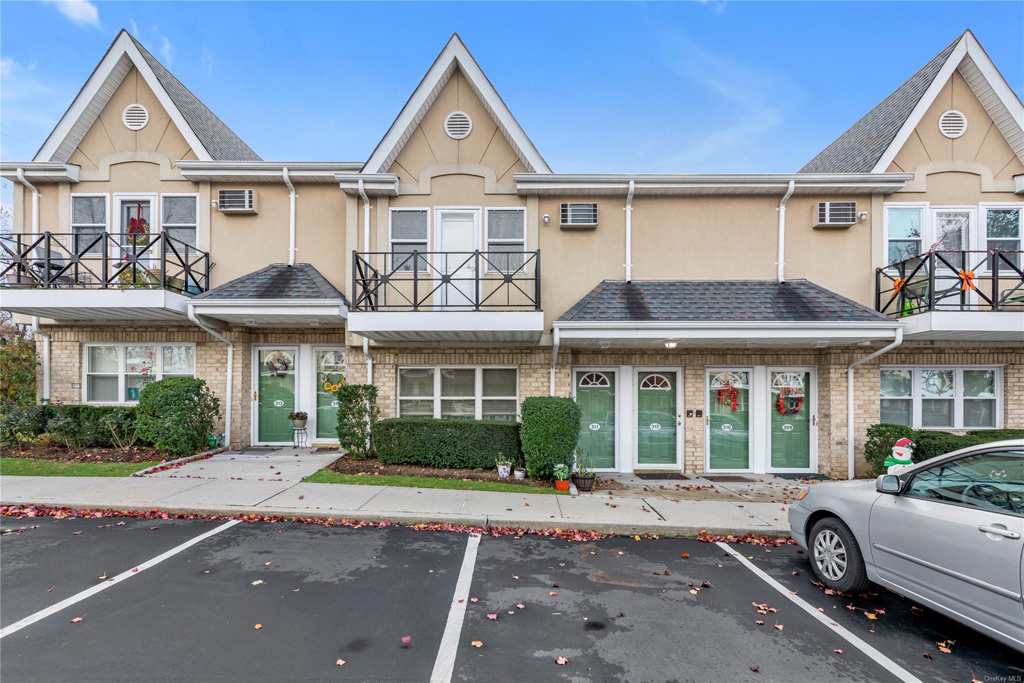 Townhome / multi-family property with a wall mounted AC and french doors