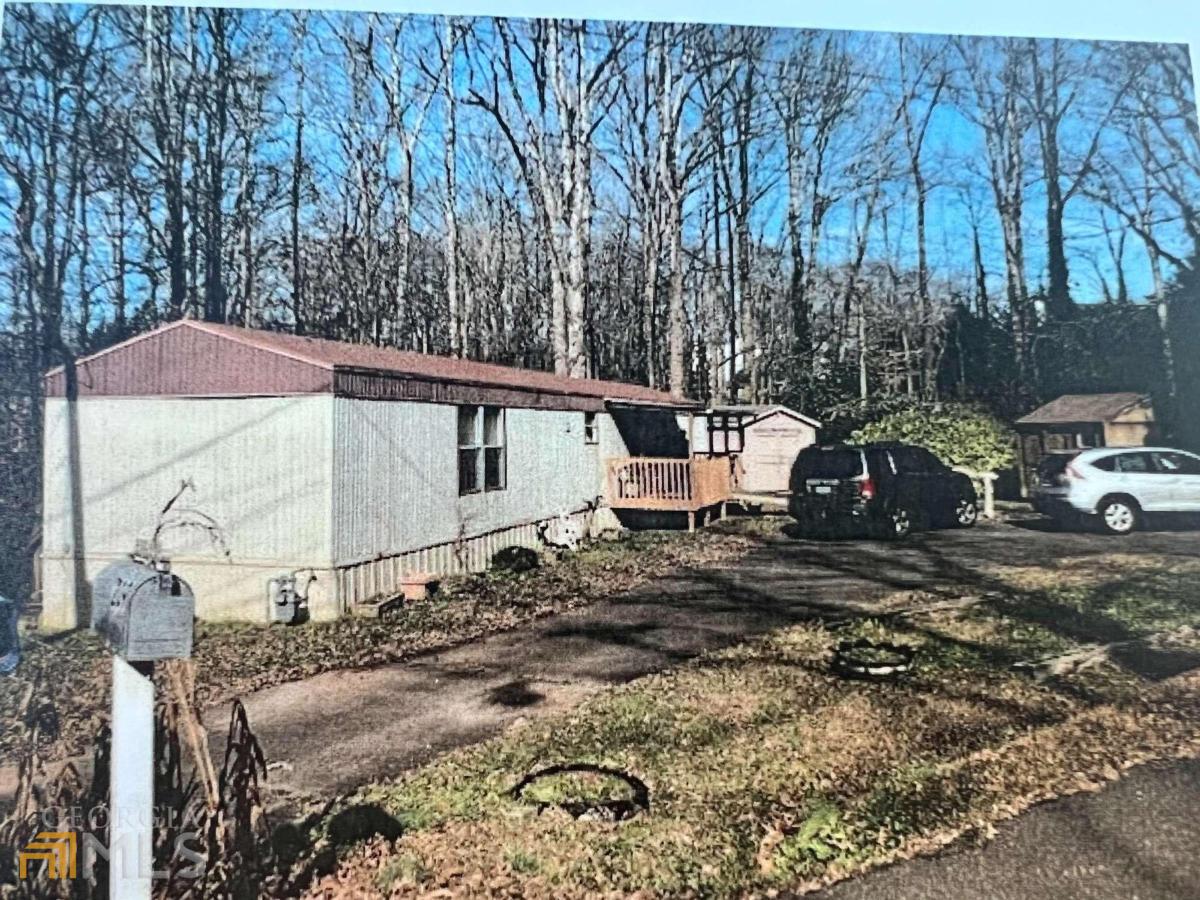 a view of backyard with a car parked in it