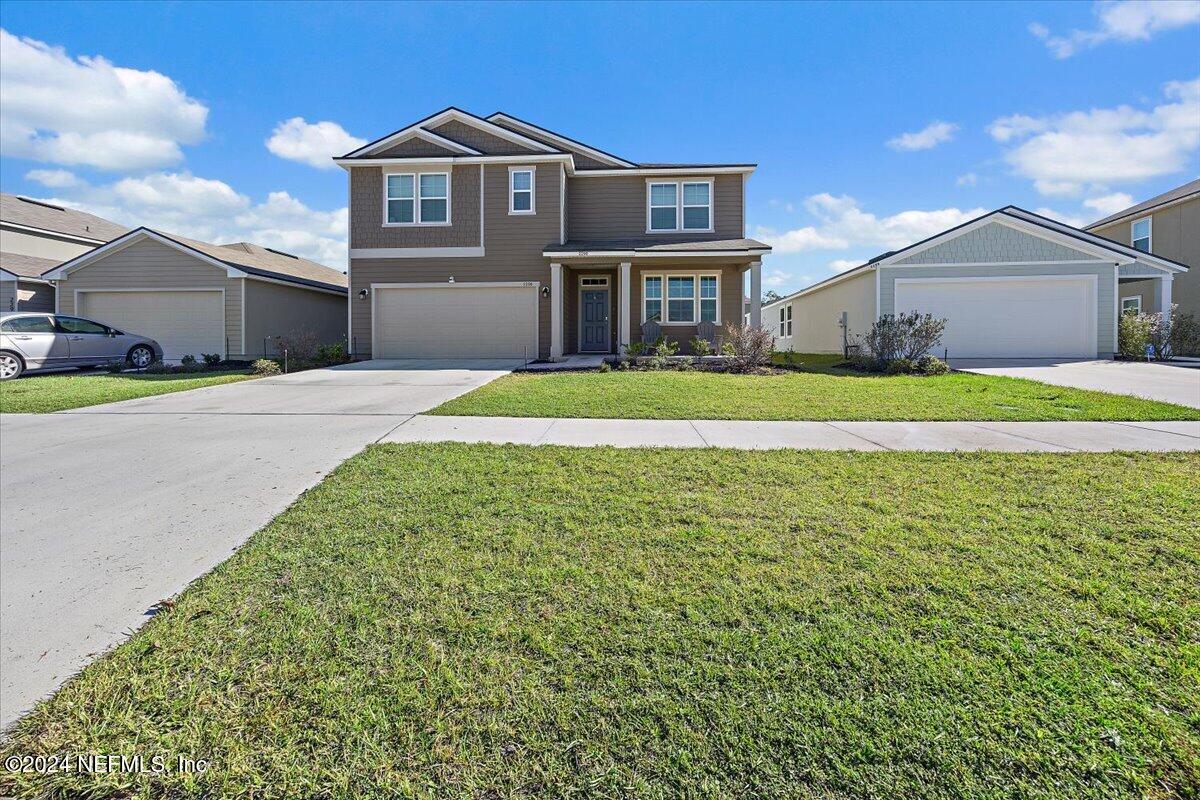 a front view of a house with a yard and garage