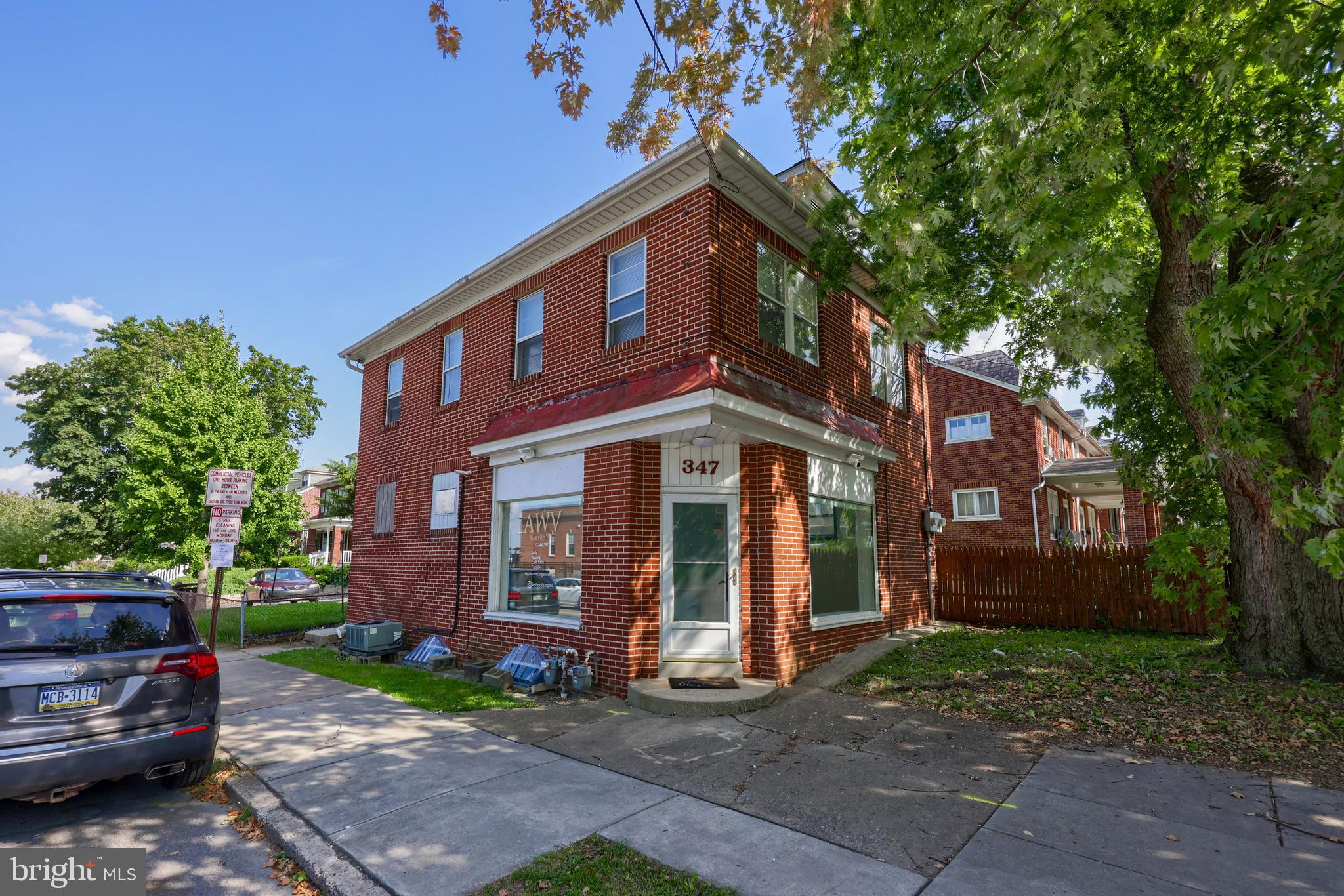 a view of a large brick building next to a yard