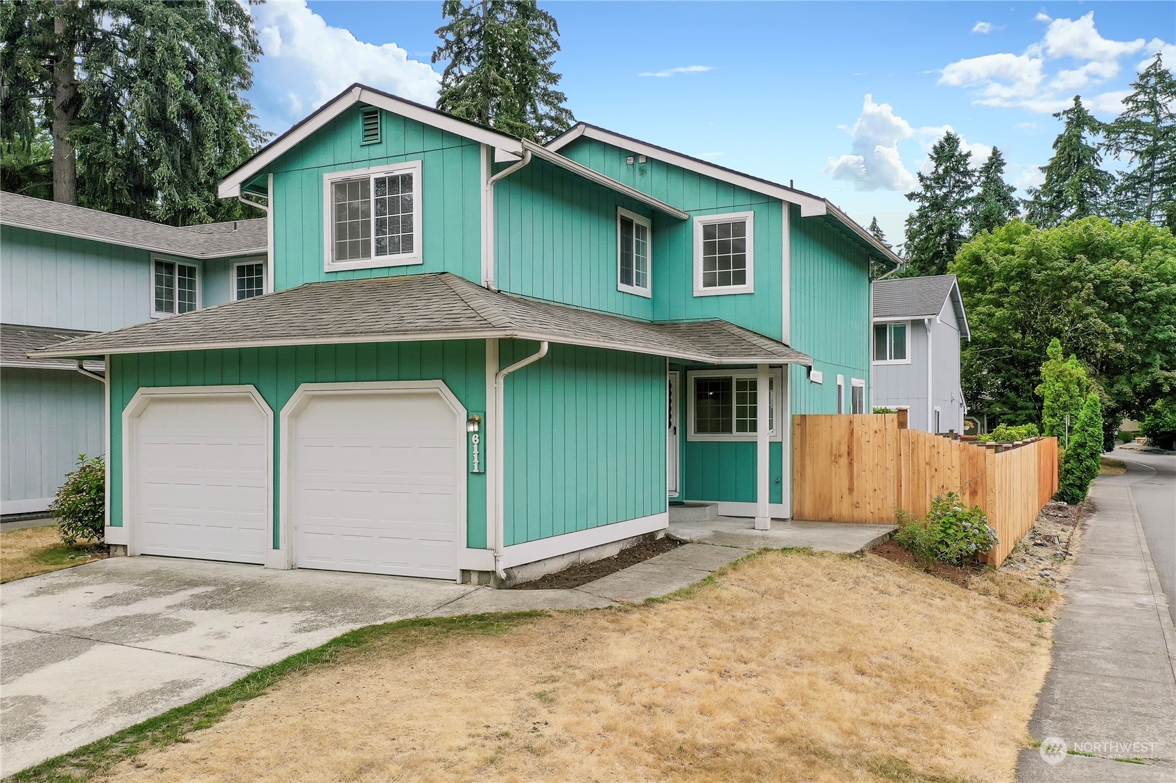 a front view of a house with a garage and yard