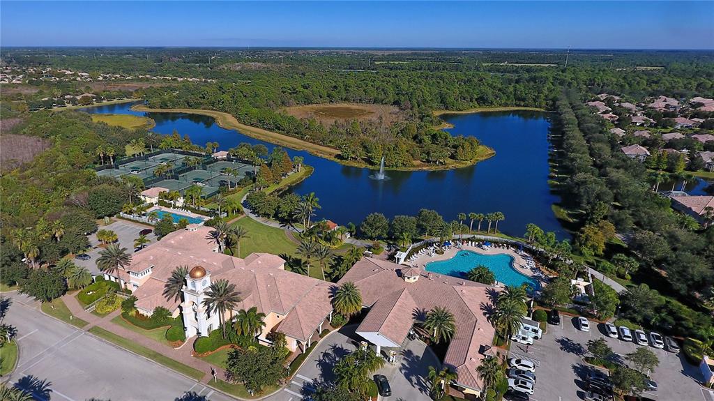 an aerial view of a house with a garden and lake view