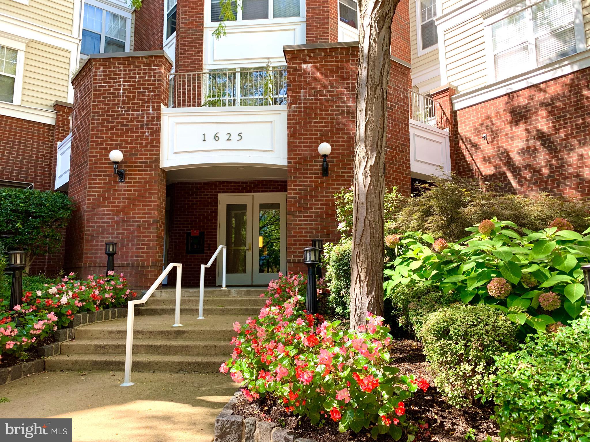 a front view of a building with flowers