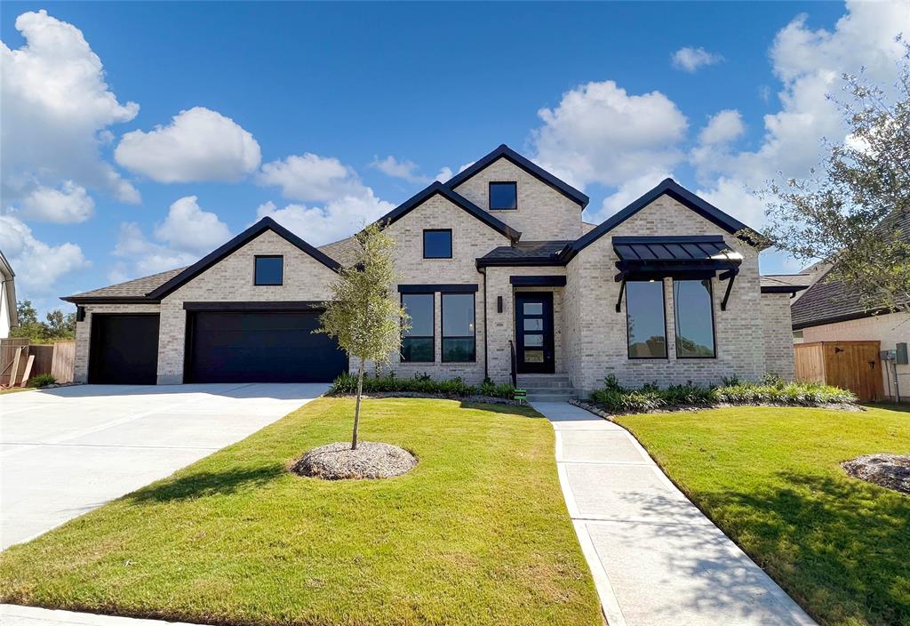 a front view of a house with yard and garage