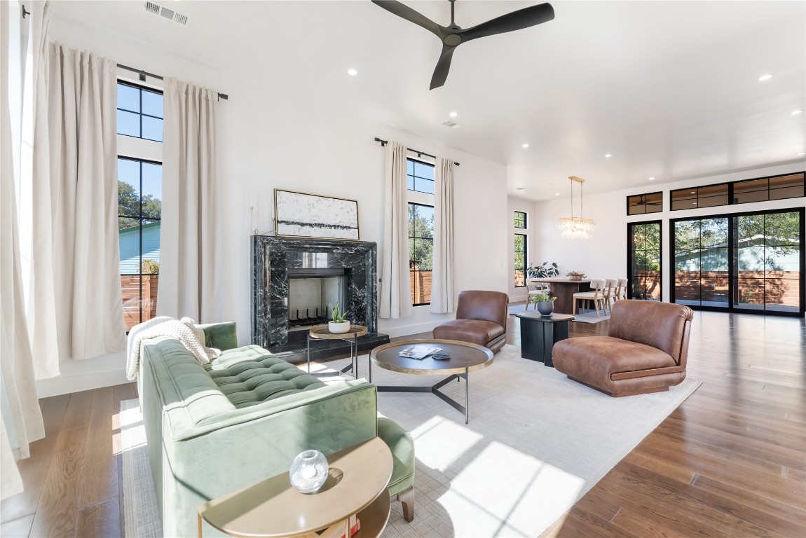 a living room with fireplace furniture and a large window