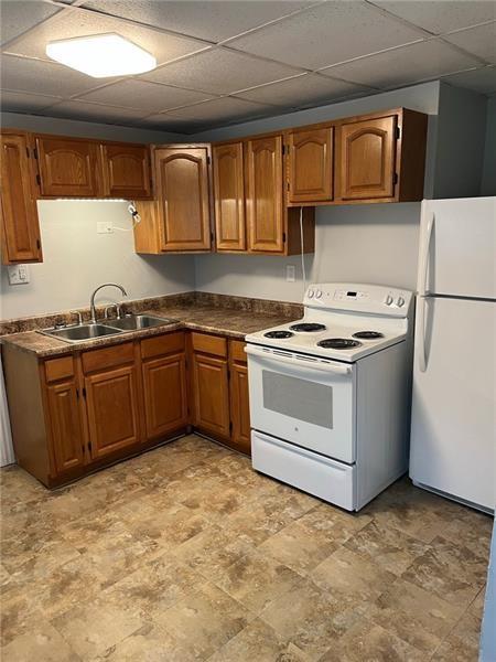 a kitchen with stainless steel appliances granite countertop a stove sink and cabinets