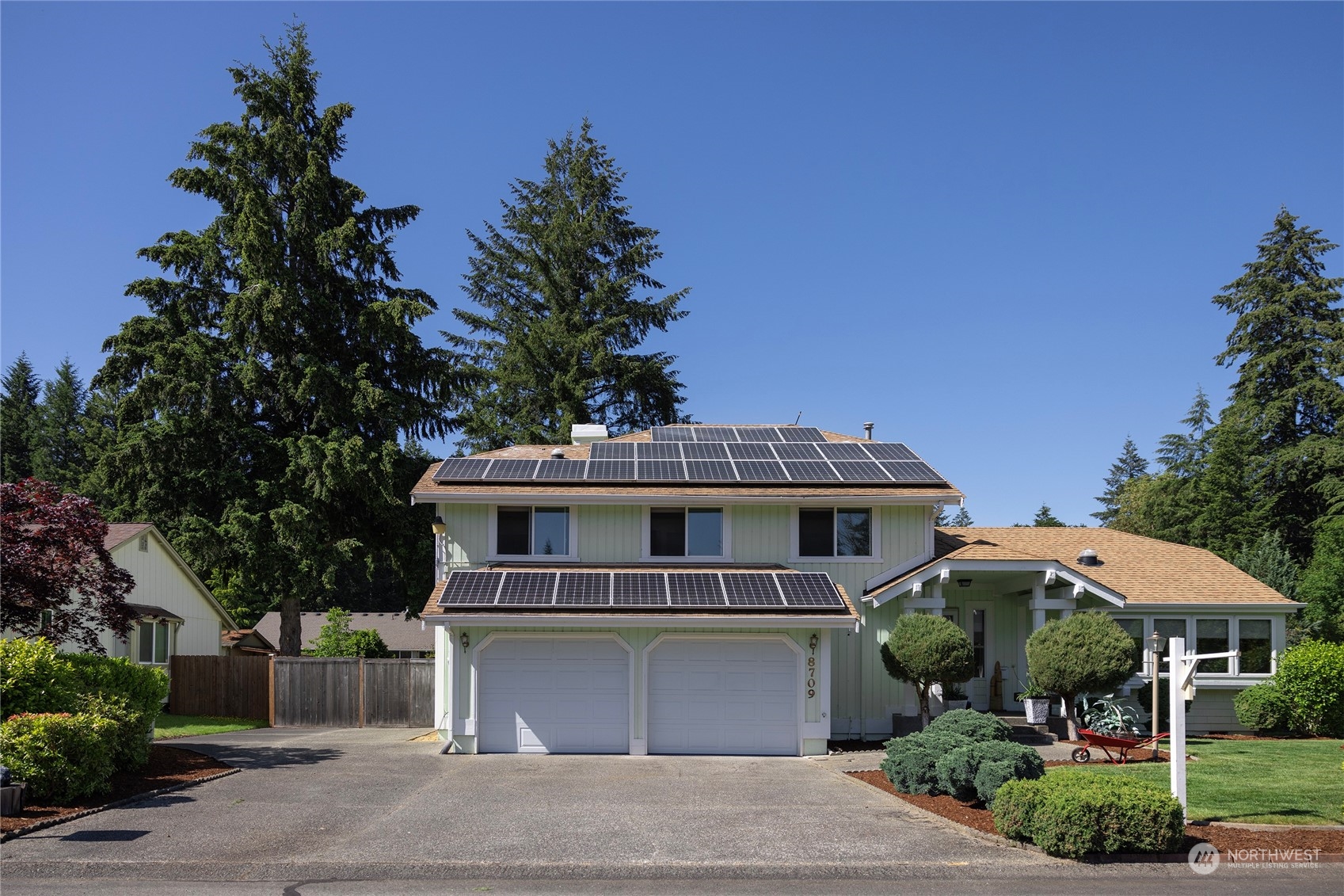 a front view of a house with yard and green space