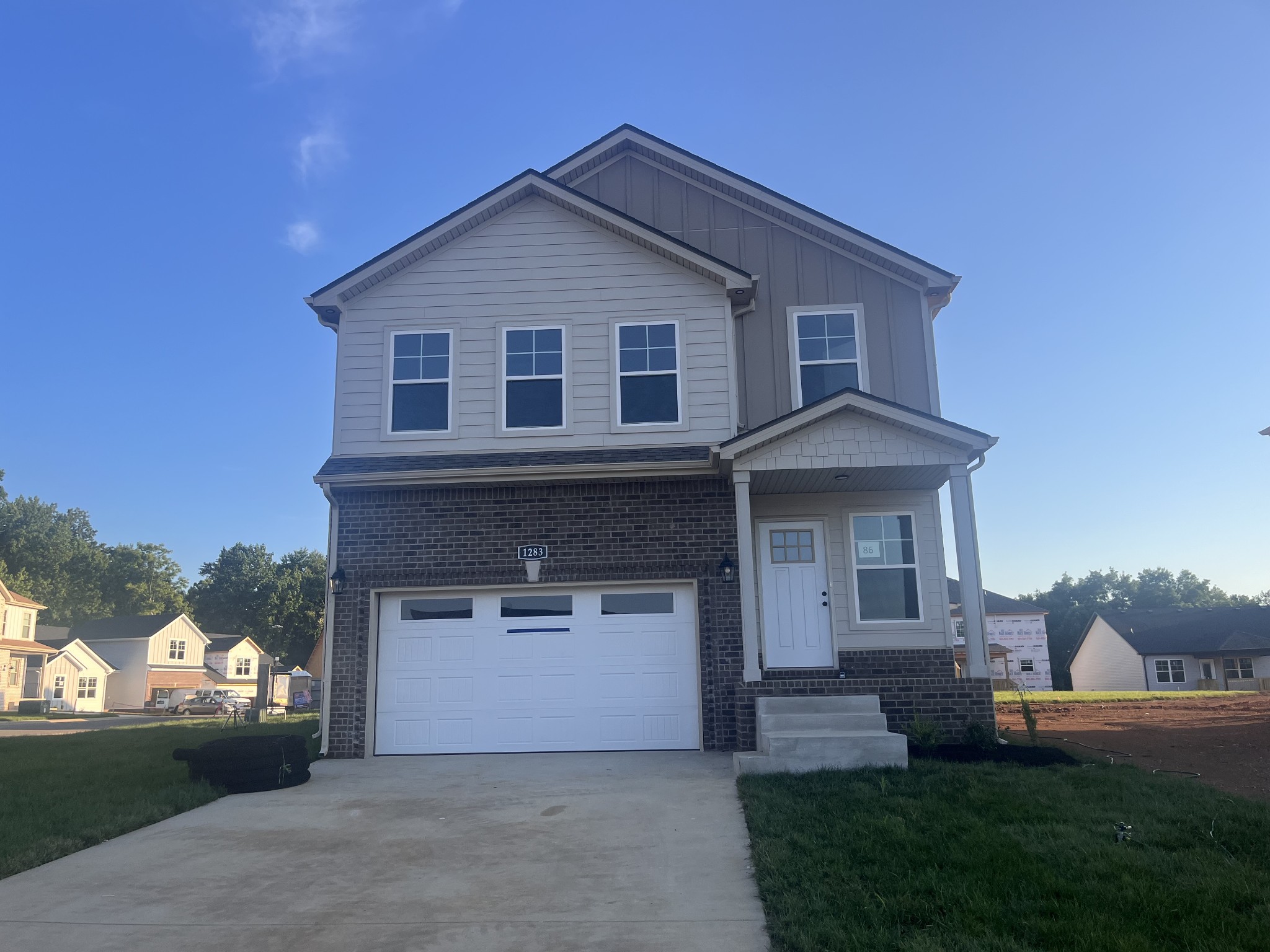 a front view of a house with a yard and garage