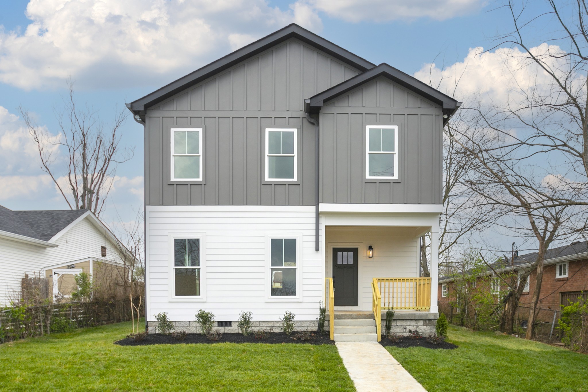 a view of a yard in front view of a house