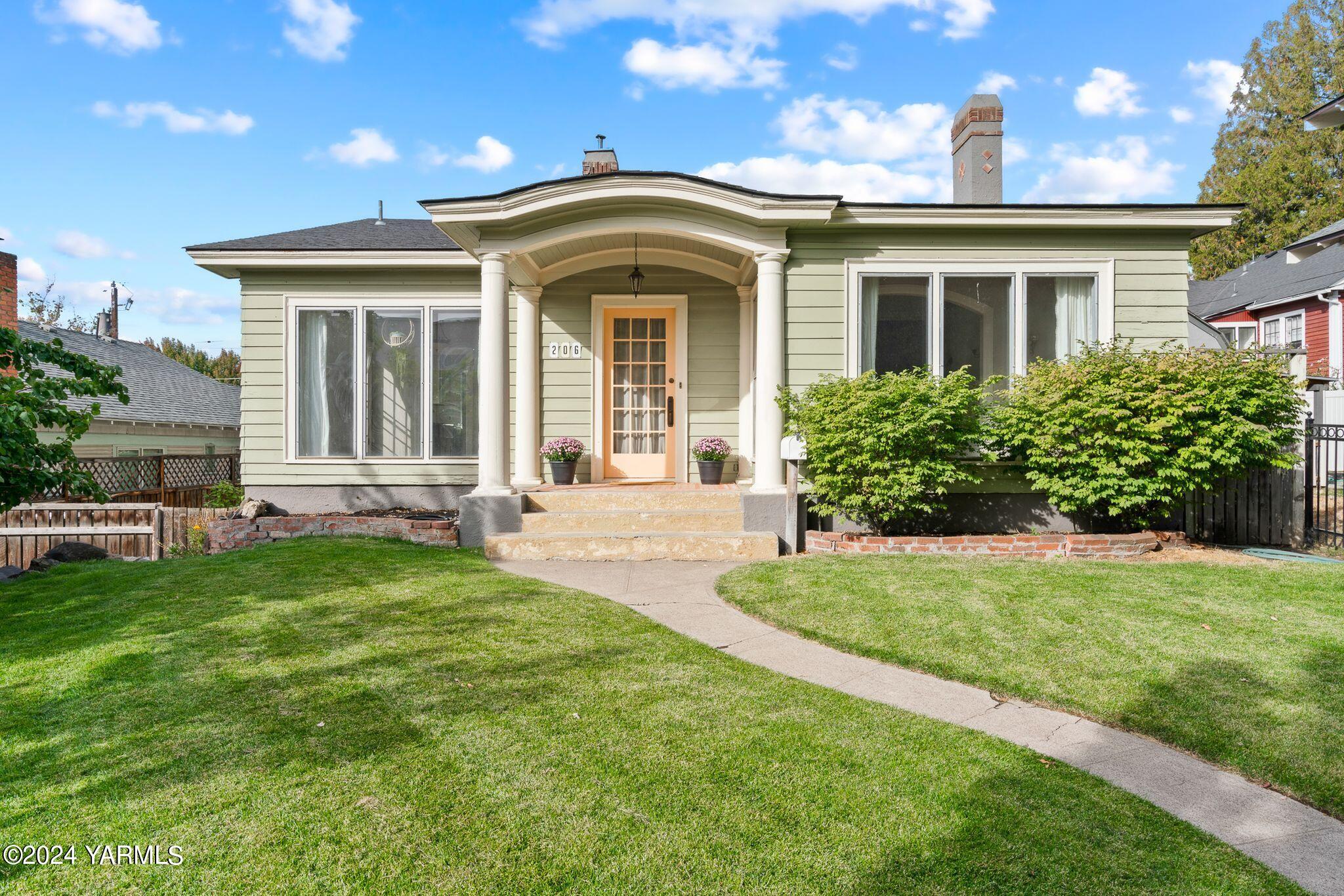 a front view of a house with a garden