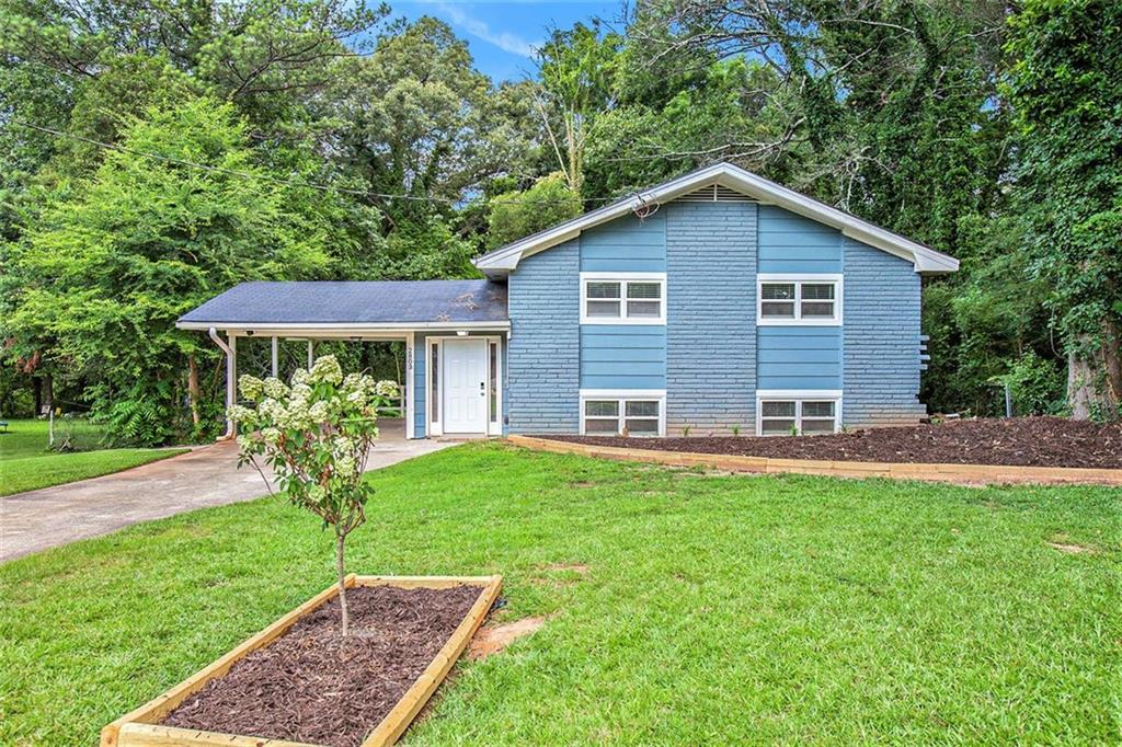 a view of a house with a yard and porch